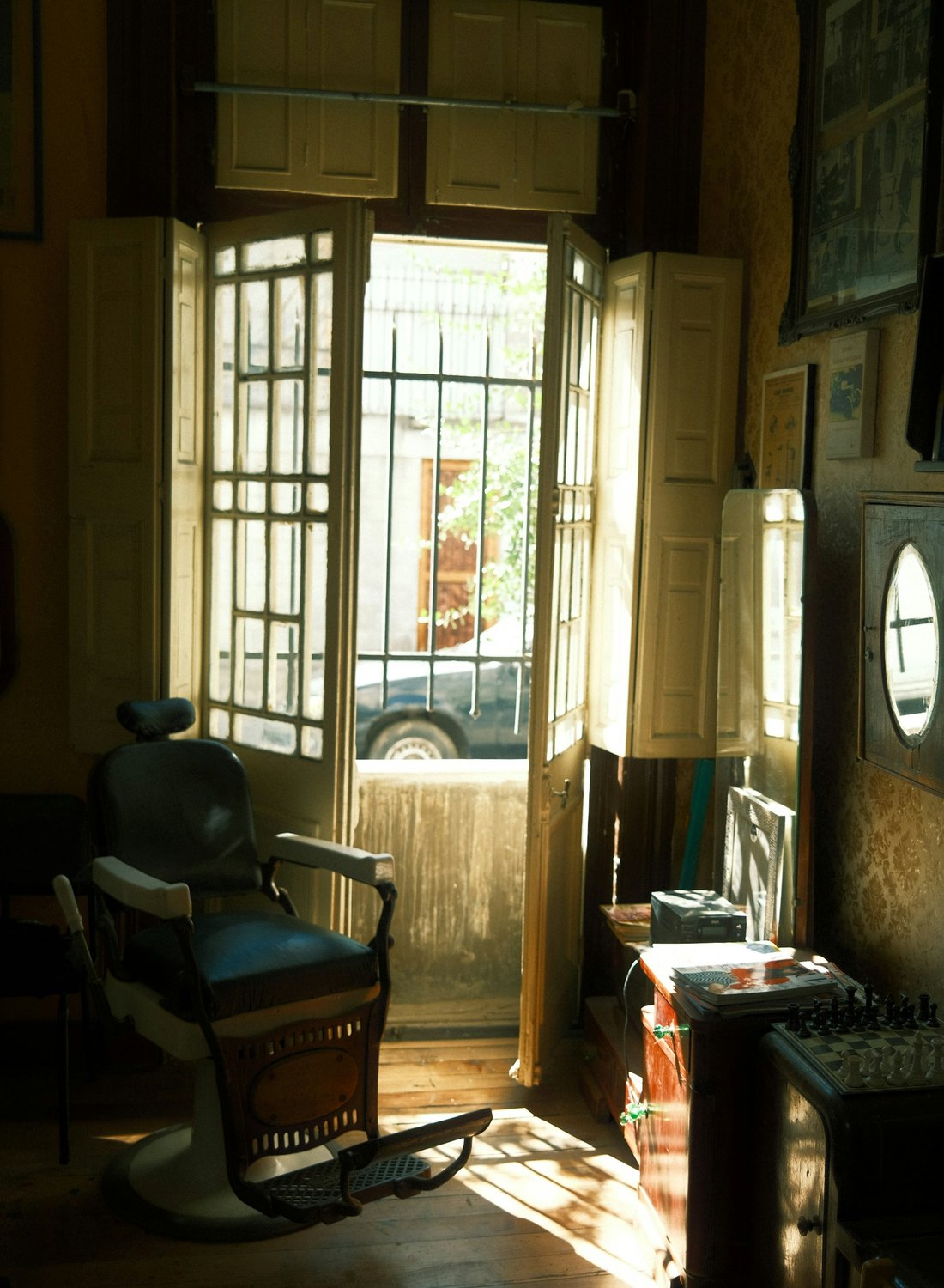 The shop door propped open onto the street, sunlight across the floor